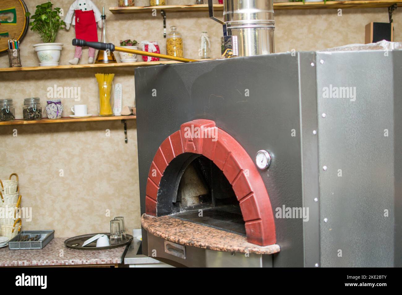 cooking pizza in the oven . Pizza near the stone stove with fire. Background of a traditional