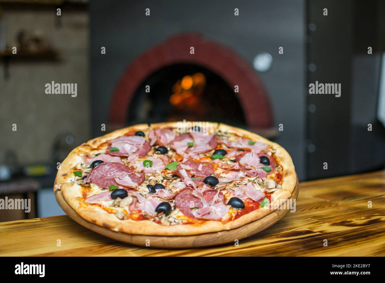 cooking pizza in the oven . Pizza near the stone stove with fire