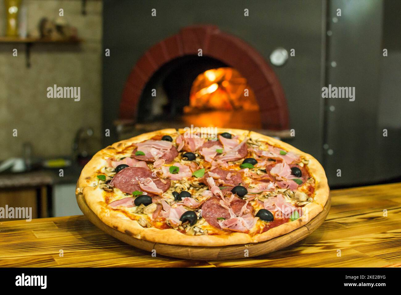 cooking pizza in the oven . Pizza near the stone stove with fire