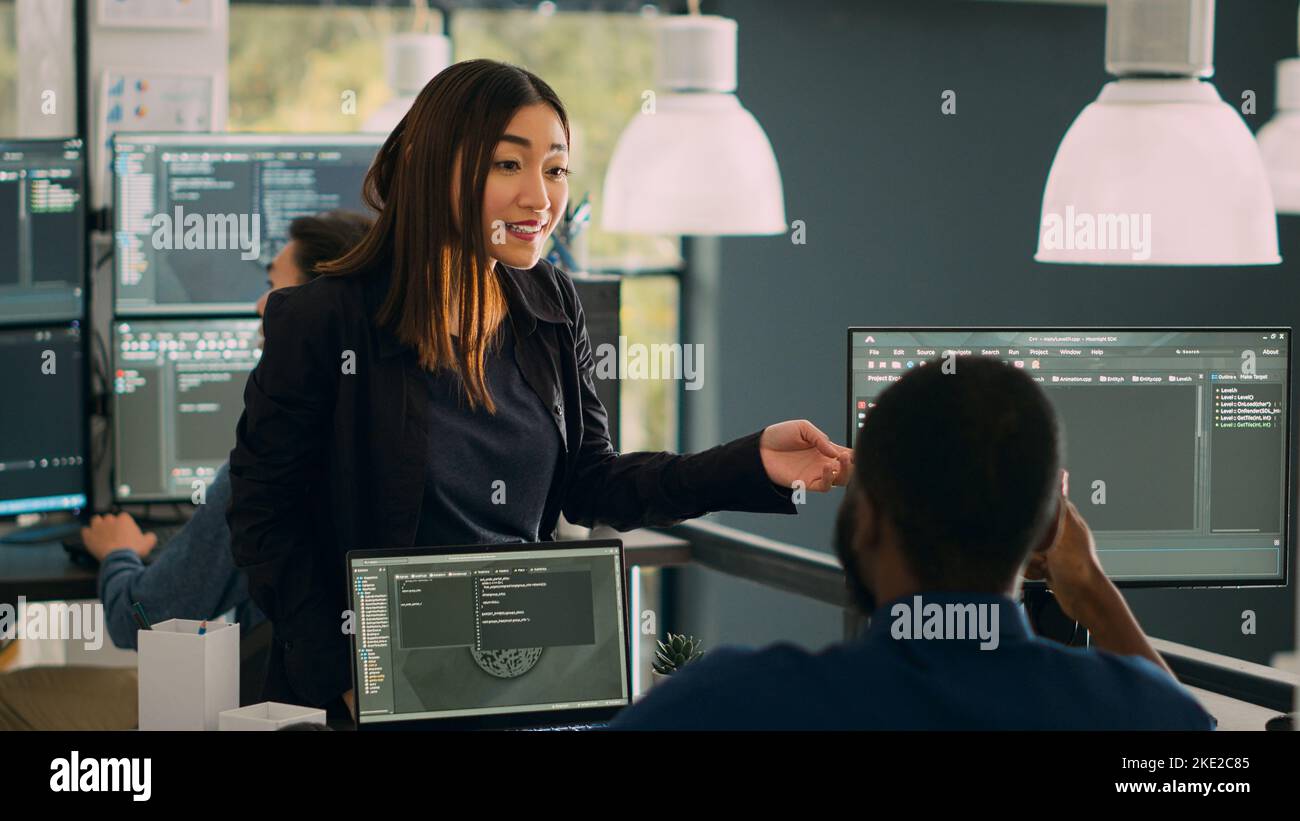 Database admins doing highfive gesture to celebrate coding achievement, enjoying successful source code development. Working on cloud computing program with html script. Handheld shot. Stock Photo