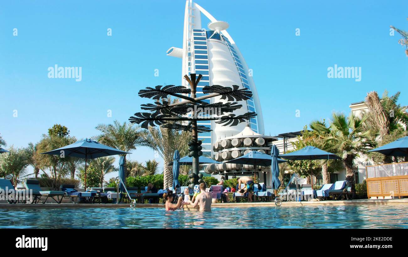 DUBAI, UNITED ARAB EMIRATES, UAE - NOVEMBER 20, 2017: Hotel JUMEIRAH AL NASEEM , near Burj al Arab. family vacation with little babies, relax near swimming pool. ,people play, swim in pool water. High quality photo Stock Photo
