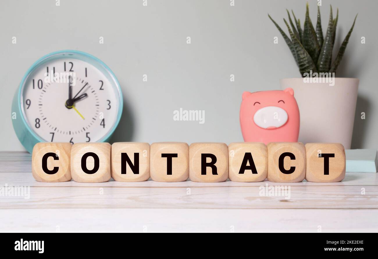 On a light background on wooden cubes the word CONTRACT is written. Business concept. Stock Photo