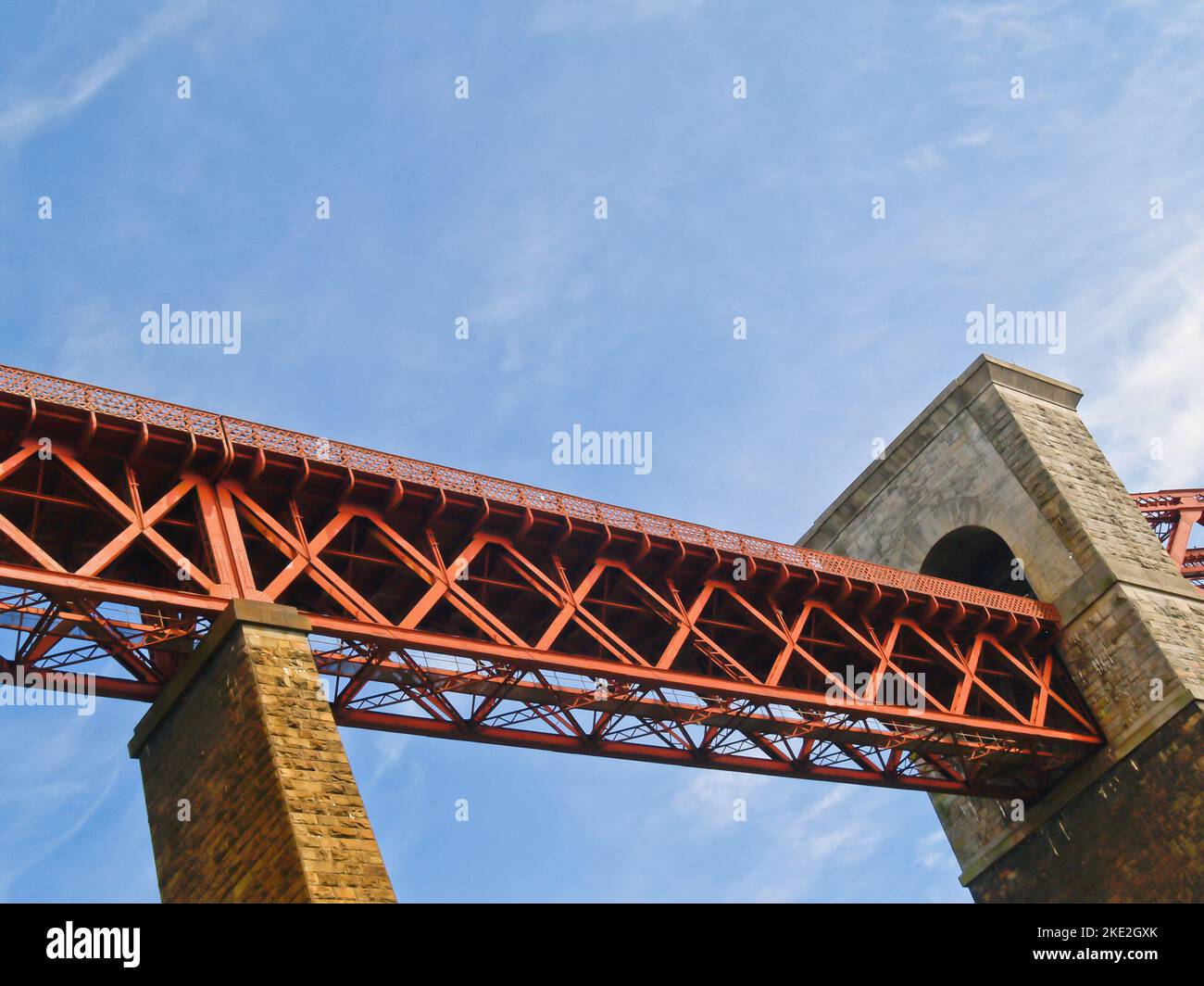 Red steel cantilever span on North Queensferry Railway Forth Bridge across Firth of Forth in Scotland. Stock Photo
