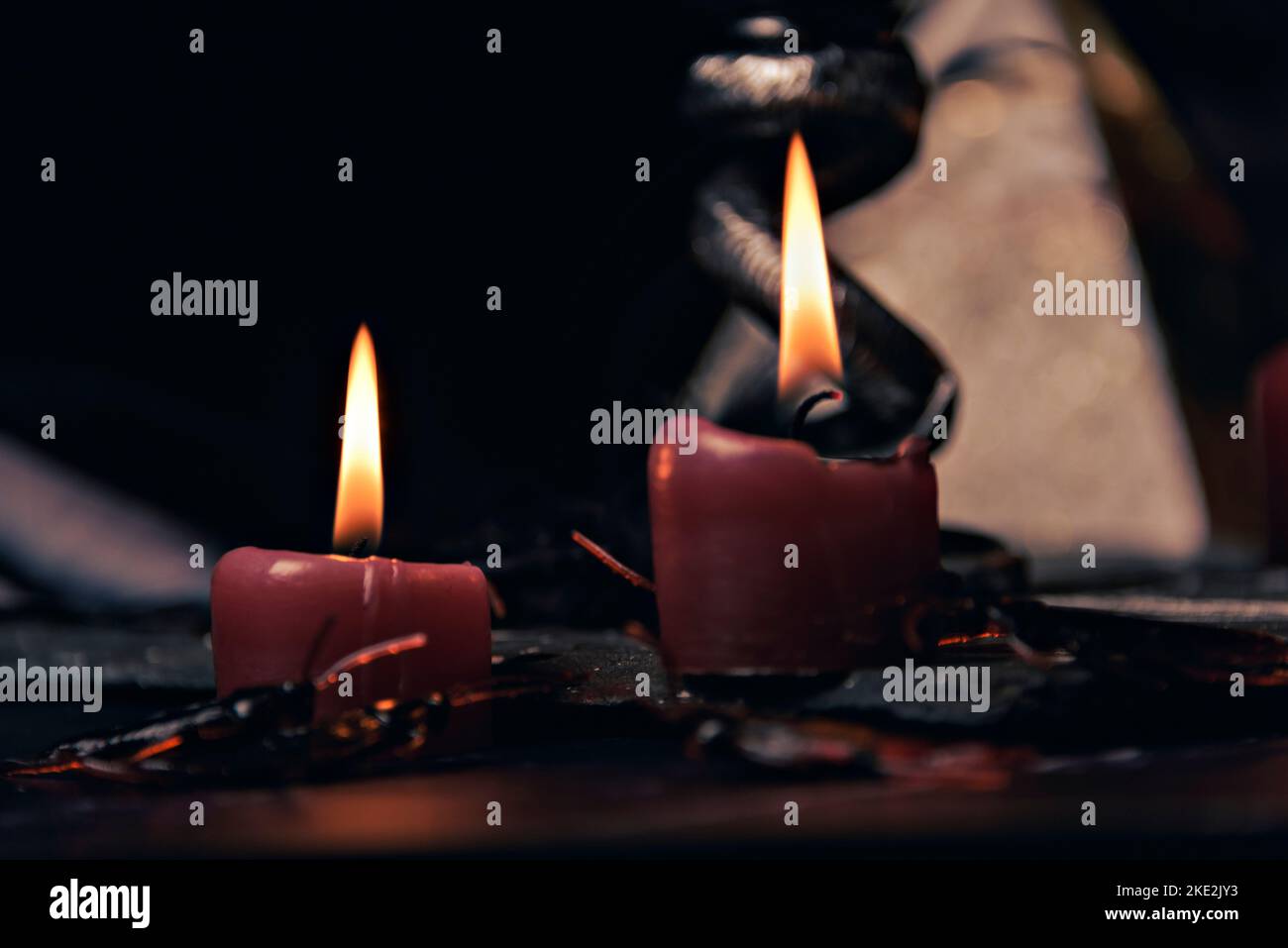 Witchcraft composition with candles, magic book and pentagram symbol. Altar for satanic rituals. Black magic and occult objects Stock Photo