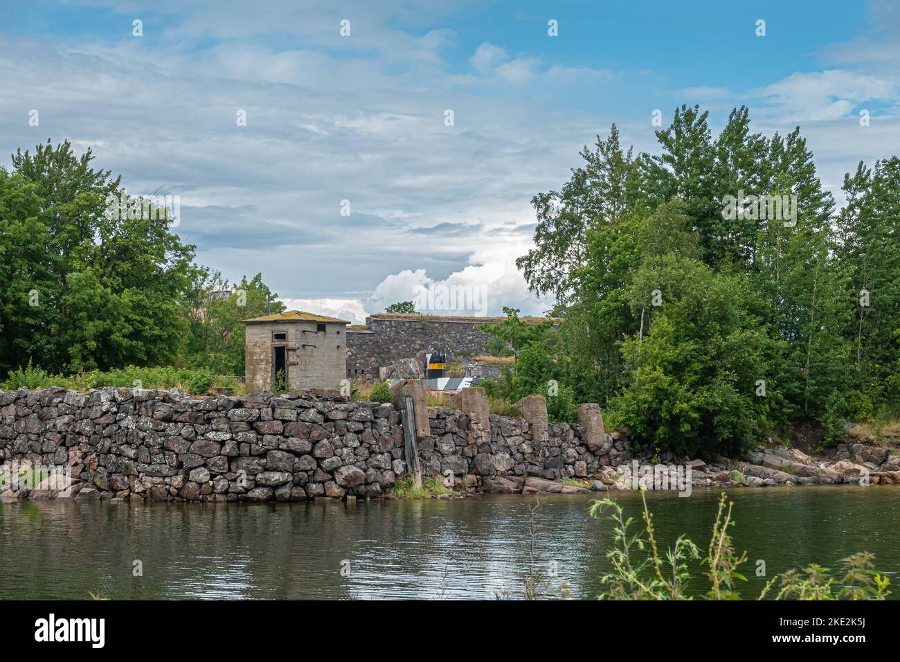Helsinki, Finland - July 19, 2022: Suomenlinna Fortress. Forward placed guard shed at sea shoreline outside Gyllenborg Bastion under blue cloudscape. Stock Photo