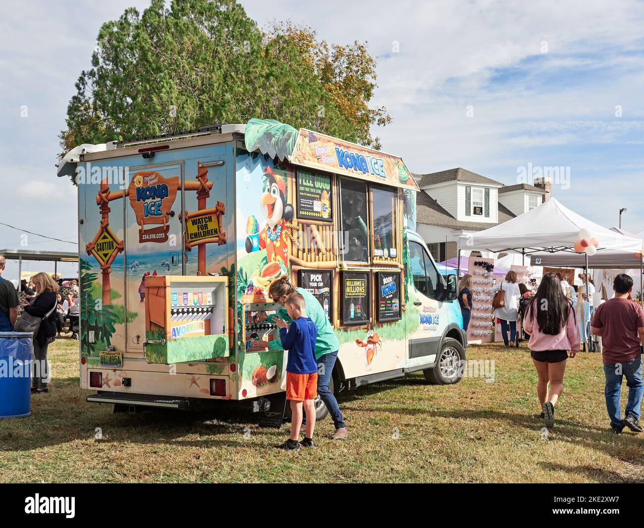 Mother and son buying and fixing snow cones at the Kona Ice truck at a family arts and crafts fair in Pike Road Alabama, USA. Stock Photo