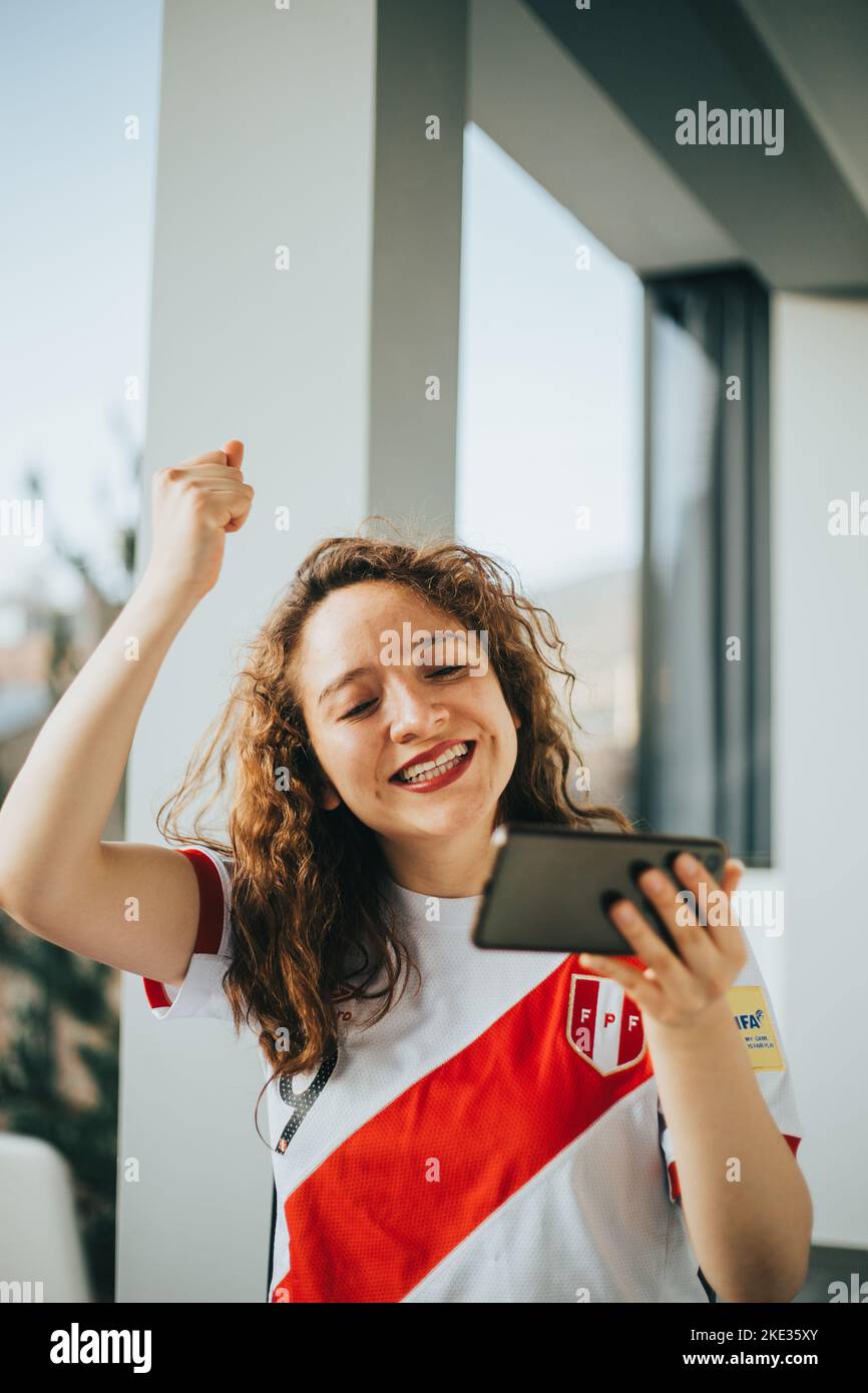 Peruvian soccer fan reacting with excitement to a soccer match by