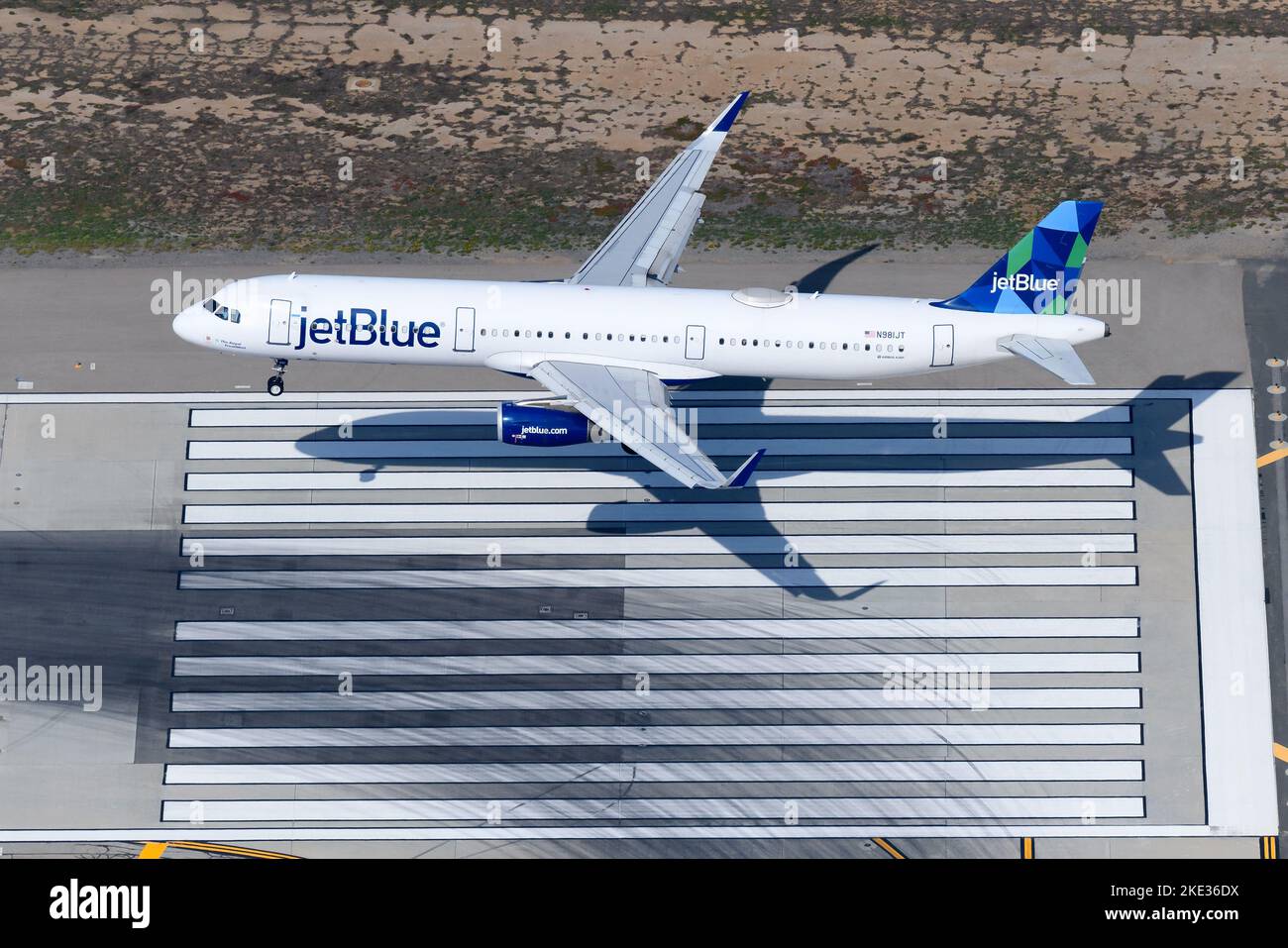 JetBlue Airbus A321 aircraft landing on airport runway. Airplane A321 of Jet Blue airline registered as N981JT from above. Stock Photo