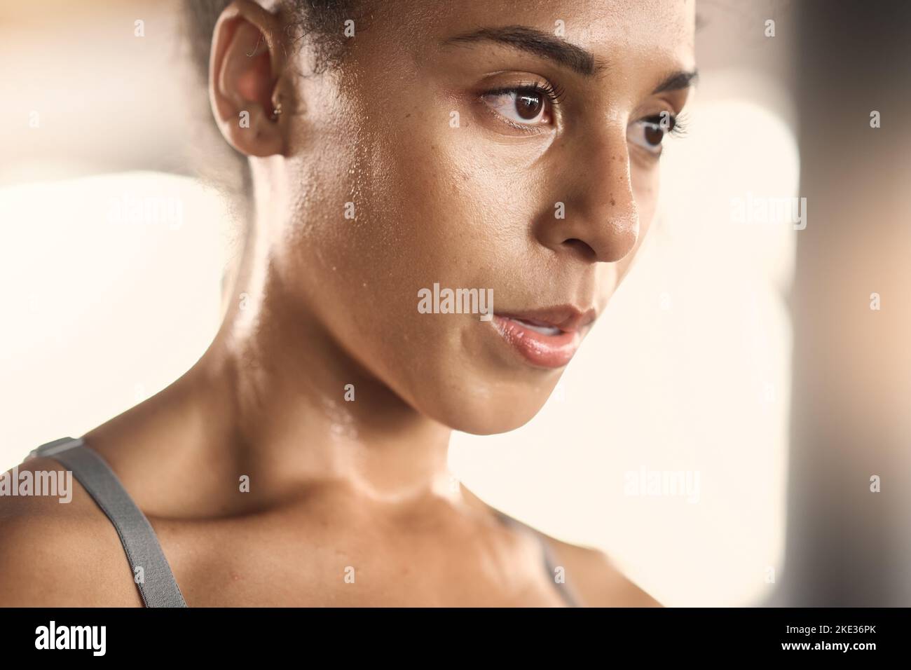Fitness, face and woman at gym for training, exercise and stop to breath, relax and rest with mockup. Mindset, focus and black woman taking a break Stock Photo