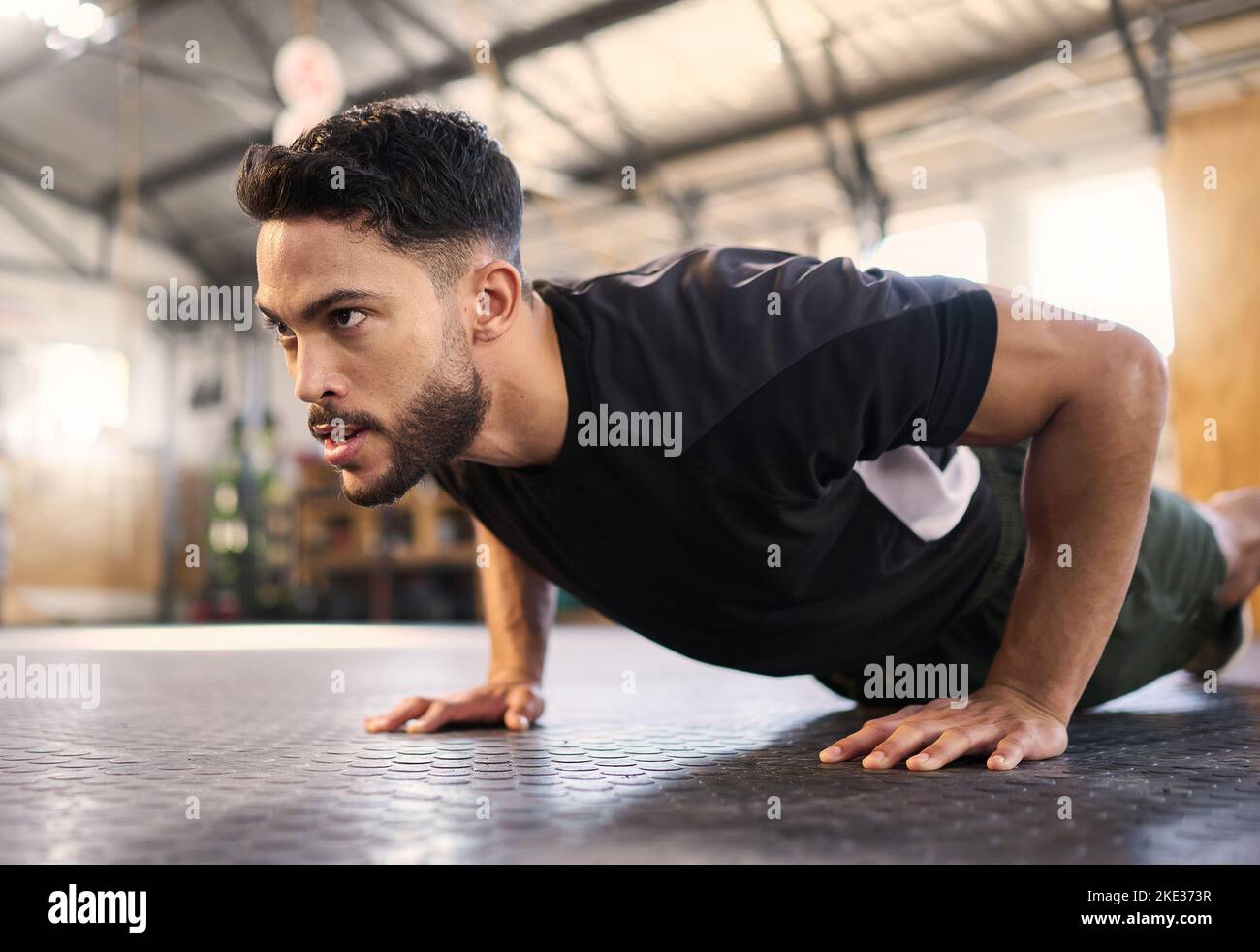 Fitness, training and push up with man in gym for training, muscle and workout endurance. Determination, strong and power with bodybuilder and floor Stock Photo