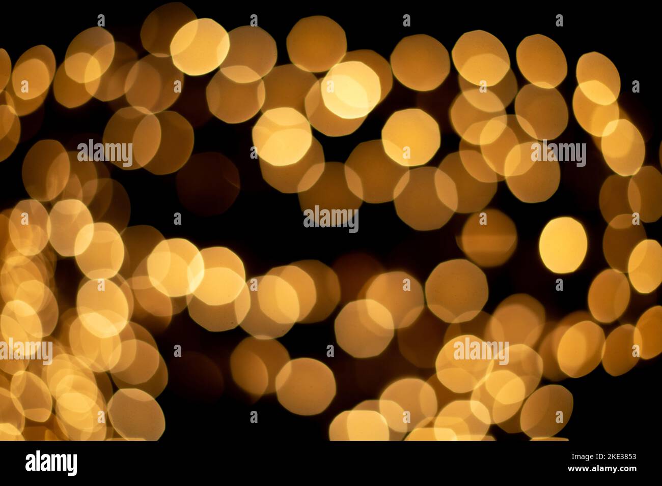 Defocused christmas gold abstract bokeh lights background. Festive lights. Blurred holiday bokeh. Stock Photo