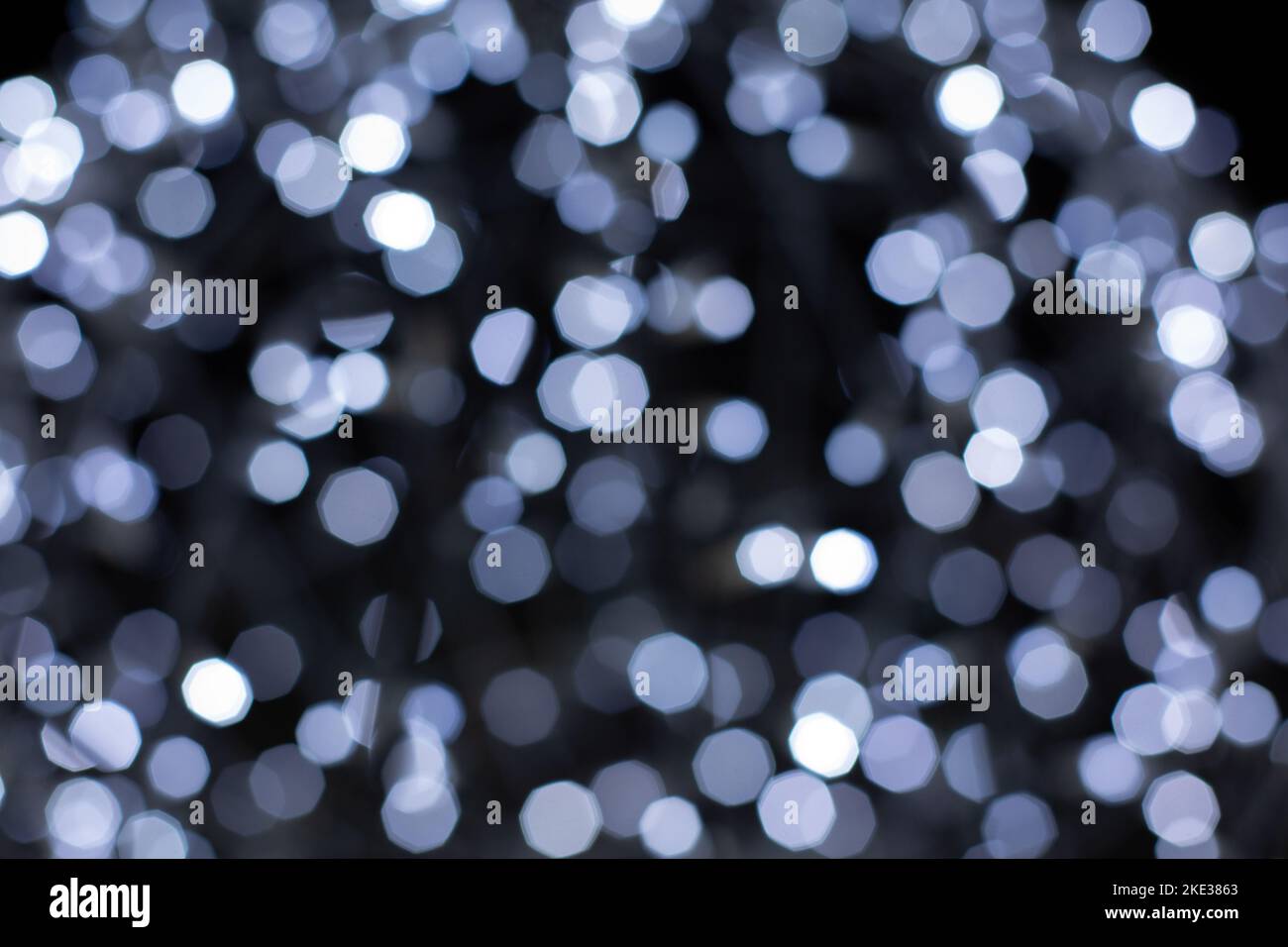 Defocused christmas grey abstract bokeh lights background. Festive lights. Blurred holiday bokeh. Stock Photo