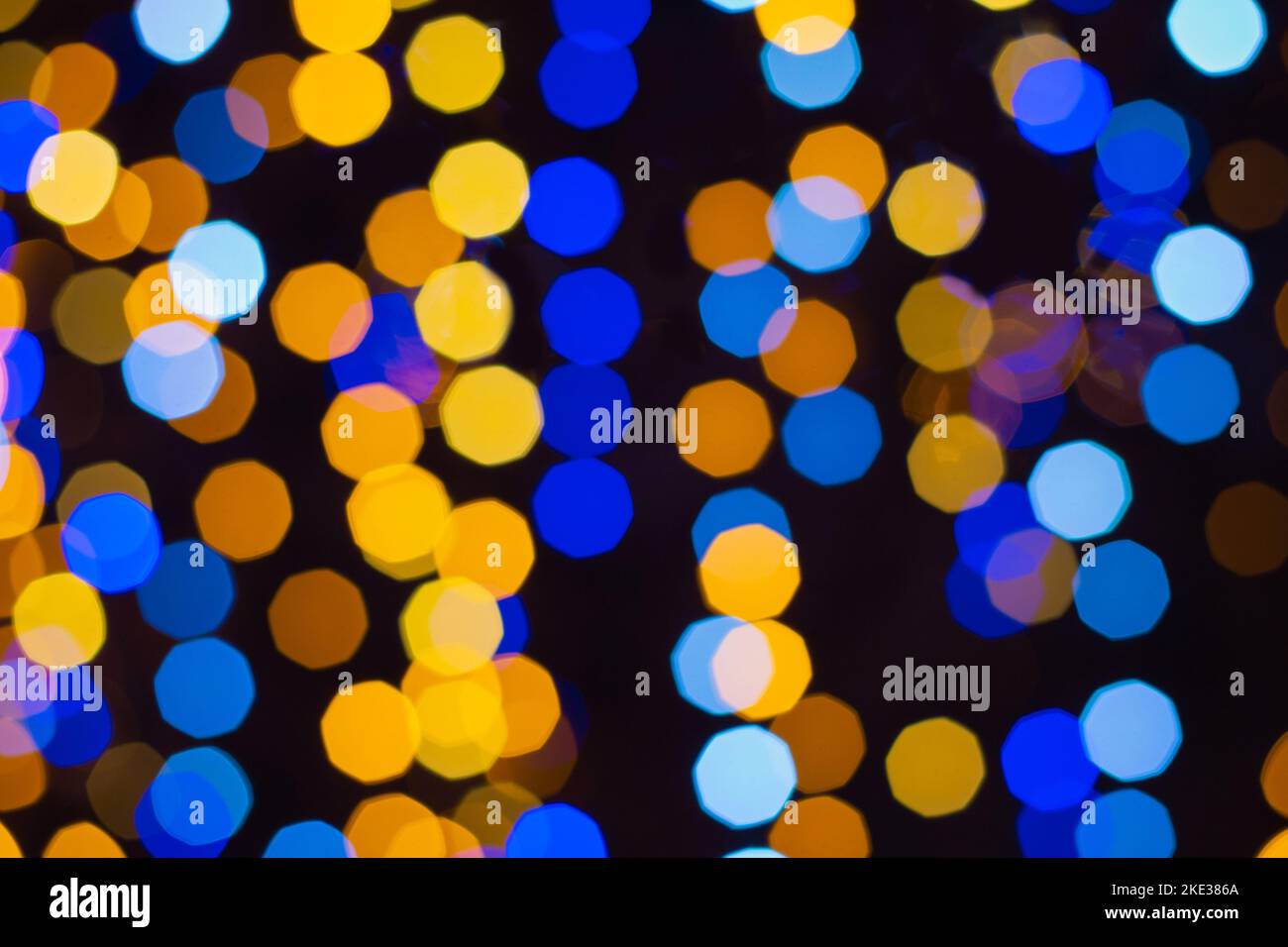 Defocused christmas yellow and blue abstract bokeh lights background. Festive lights. Blurred holiday bokeh. Stock Photo