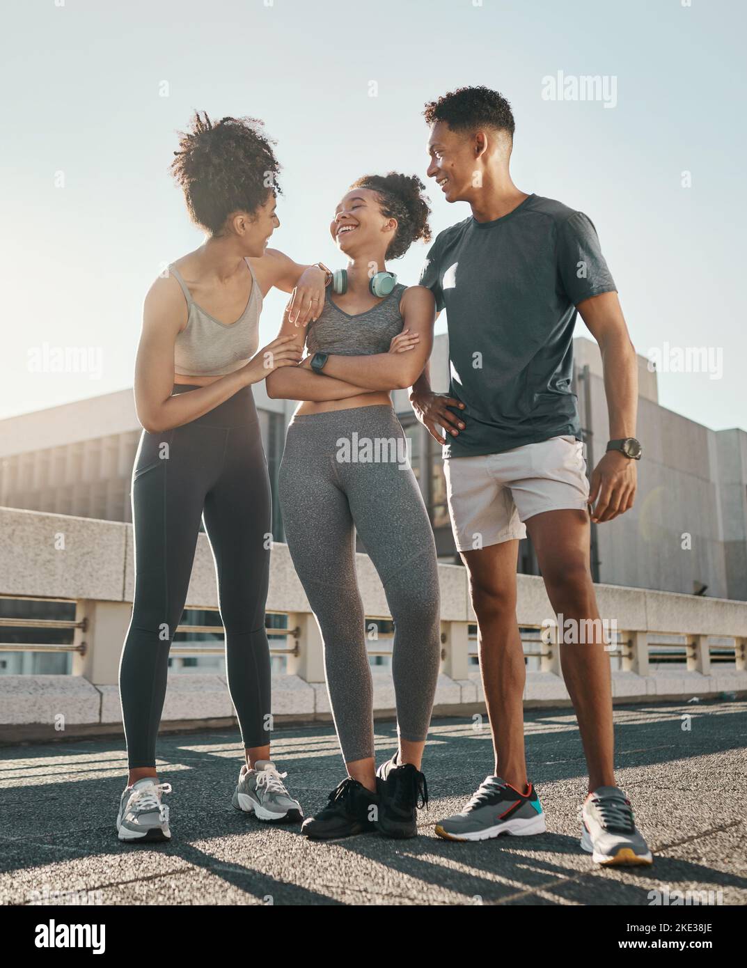 City running friends, group smile and laugh together on road after run in town for outdoor summer workout, fitness exercise and training for marathon Stock Photo