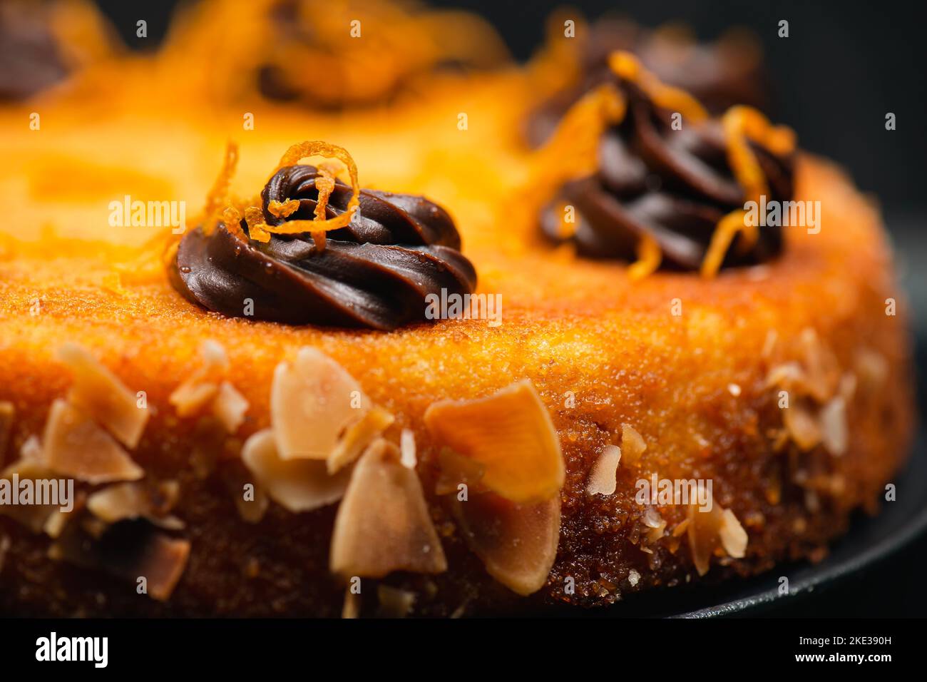 Orange flourless cake with zest, flaked almonds, and chocolate ganache