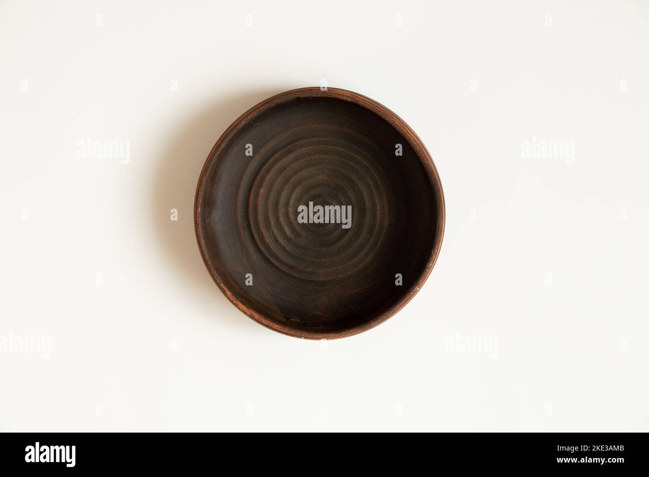 Earthenware deepware stands on a white background close-up Stock Photo