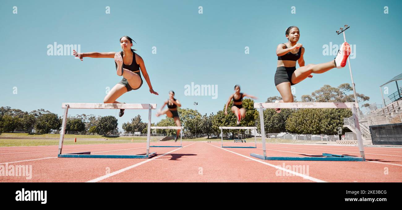 Woman, jumping and hurdles in competitive sports training, exercise or athletics on the stadium track. Women in sport fitness competition for hurdle Stock Photo