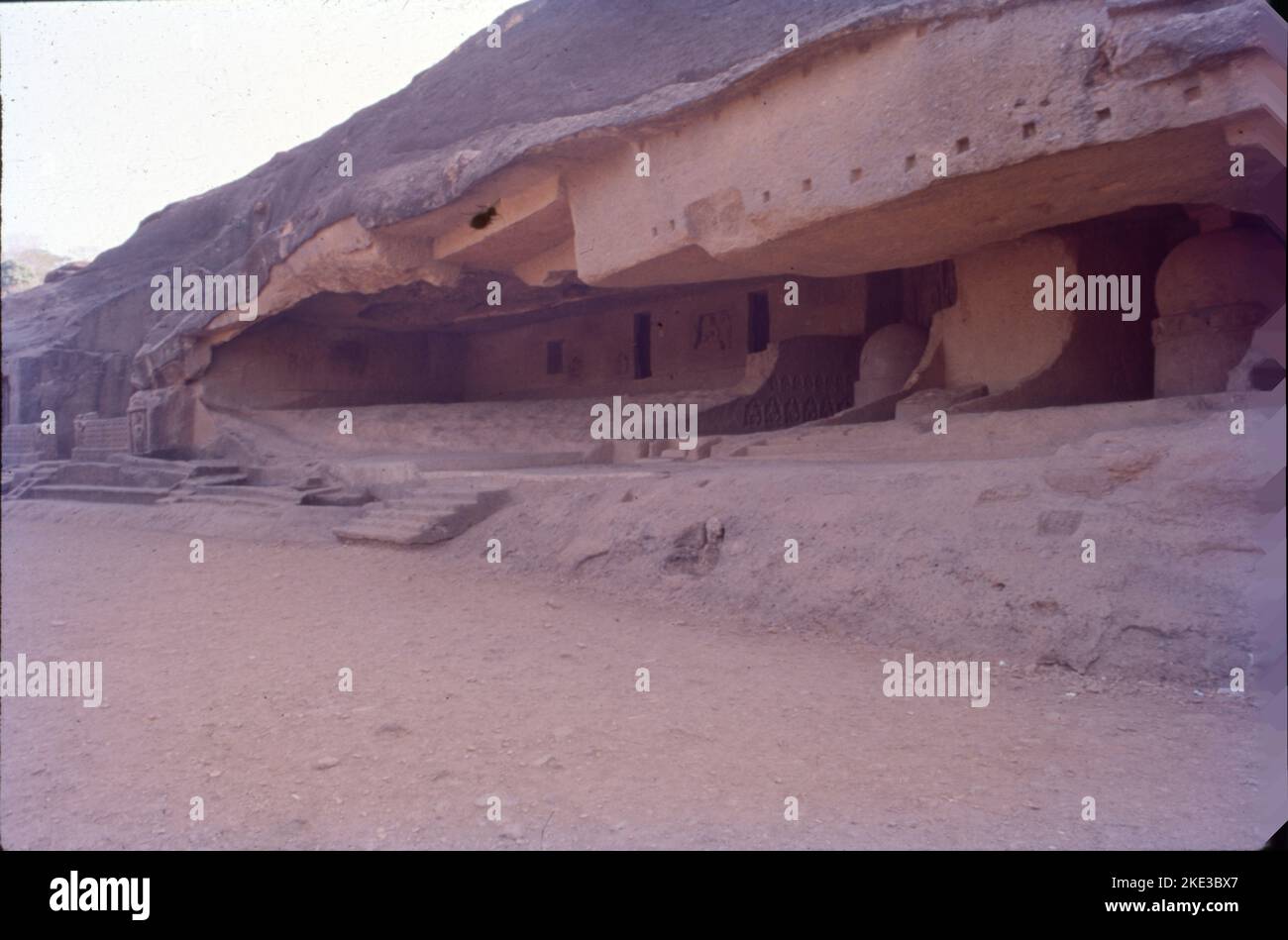 The Kanheri Caves are a group of caves and rock-cut monuments cut into a massive basalt outcrop in the forests of the Sanjay Gandhi National Park, on the former island of Salsette in the western outskirts of Mumbai,Once the caves were converted to permanent monasteries, their walls were carved with intricate reliefs of Buddha and the Bodhisattvas. Kanheri caves were built in the 1st century and had become an important Buddhist settlement on the Konkan coast by the 3rd century CE. Stock Photo