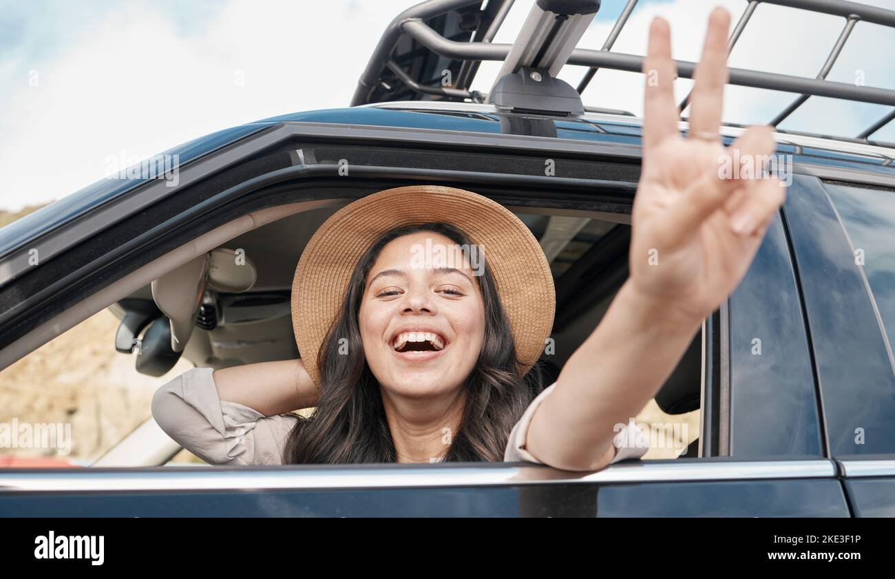 Road trip, car travel and woman, peace and sign for summer holiday