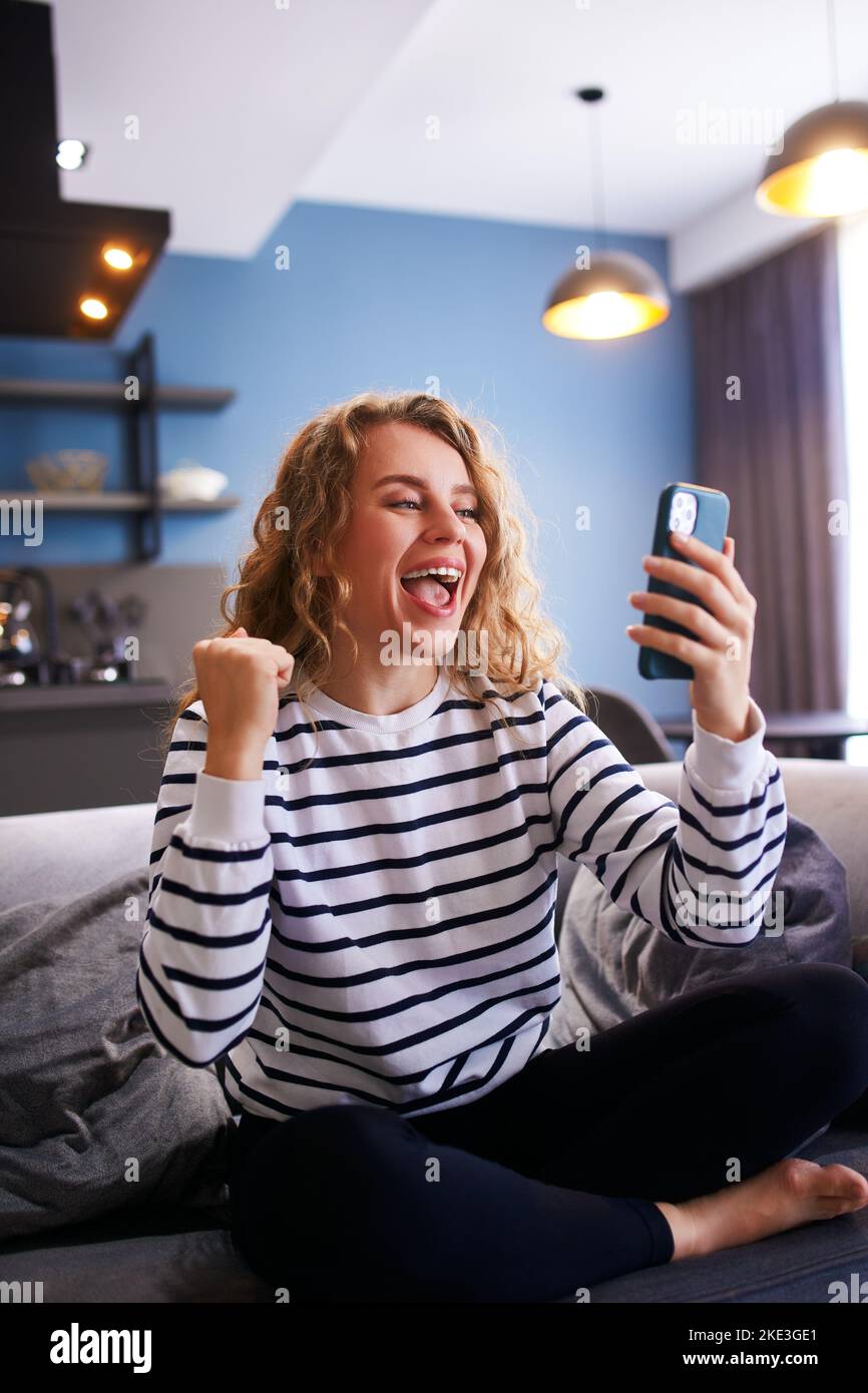 Girl rejoice celebrate college admission, scholarship approved, invitation for internship in university abroad. Woman checks e-mail, news about Stock Photo