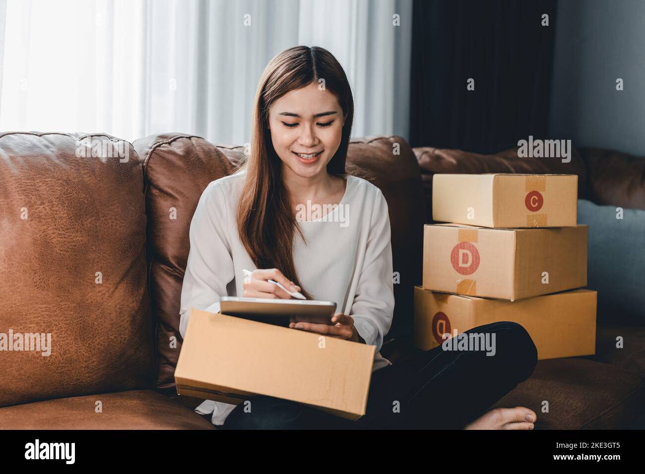 Asian female with small stock business owner holding digital tablet and