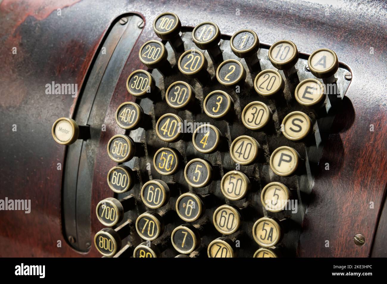 High angle of weathered retro cash register with round keys on control panel Stock Photo