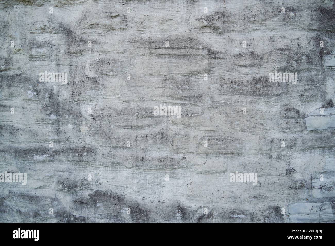 Old plastered stone wall. Dirty gray background. Stock Photo