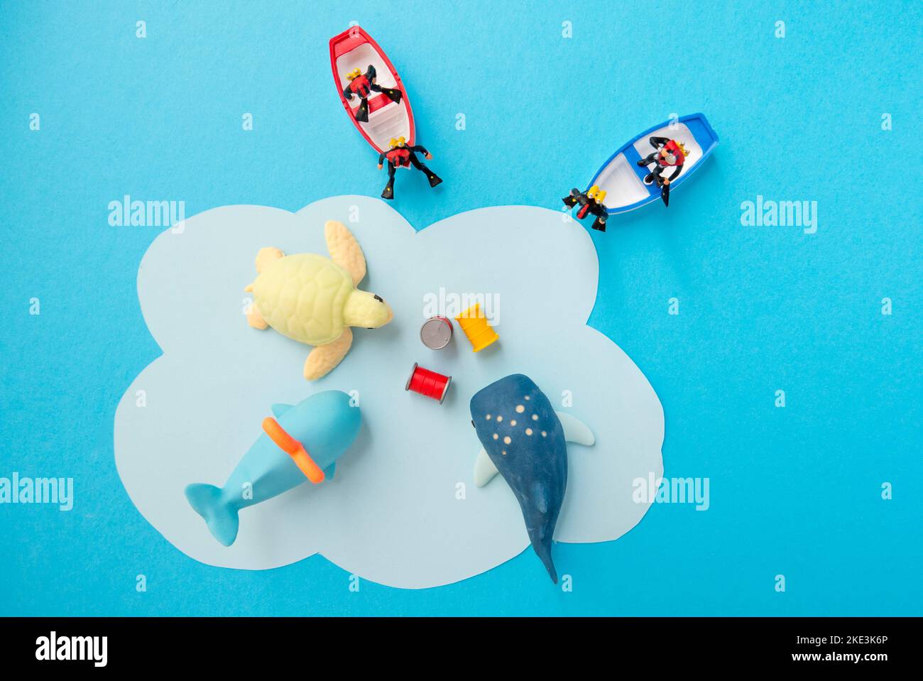 Miniature toys -  Top view toxic waste dumped to the sea, resulted in marine life destruction and ocean pollution concept. Stock Photo