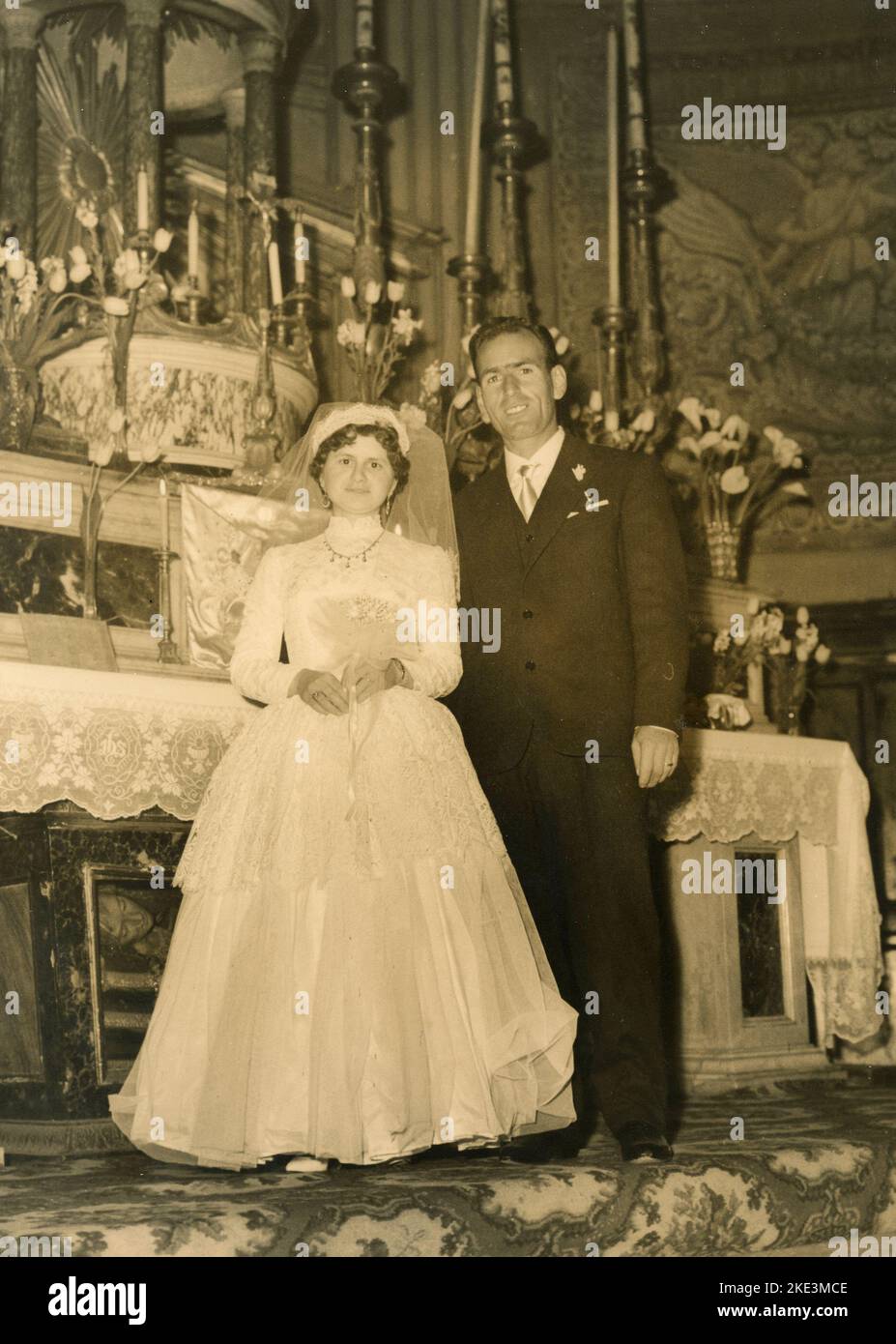 Wedding in a village in central Italy: The Bride and the Groom in the church next to the altar, 1950s Stock Photo