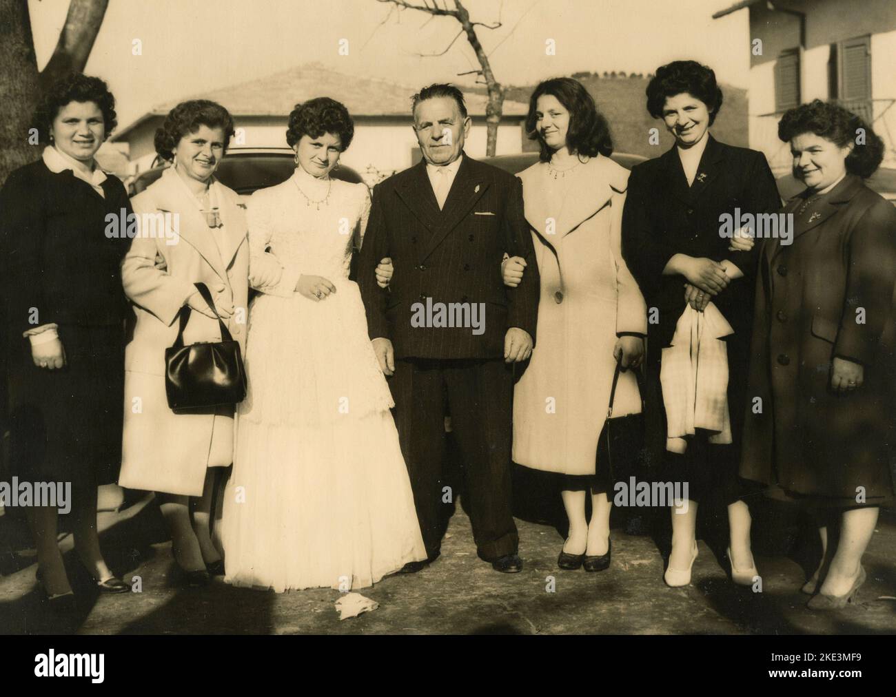 Wedding in a village in central Italy: The Bride taking photos outside with friends and relatives, 1950s Stock Photo