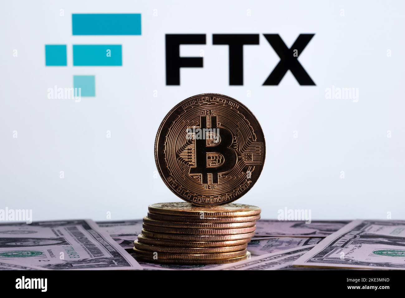 FTX Cryptocurrency Exchange bankruptcy concept. FTX logo seen on display, and stack of bitcoin tokens. Stafford, United Kindom, November 10, 2022. Stock Photo