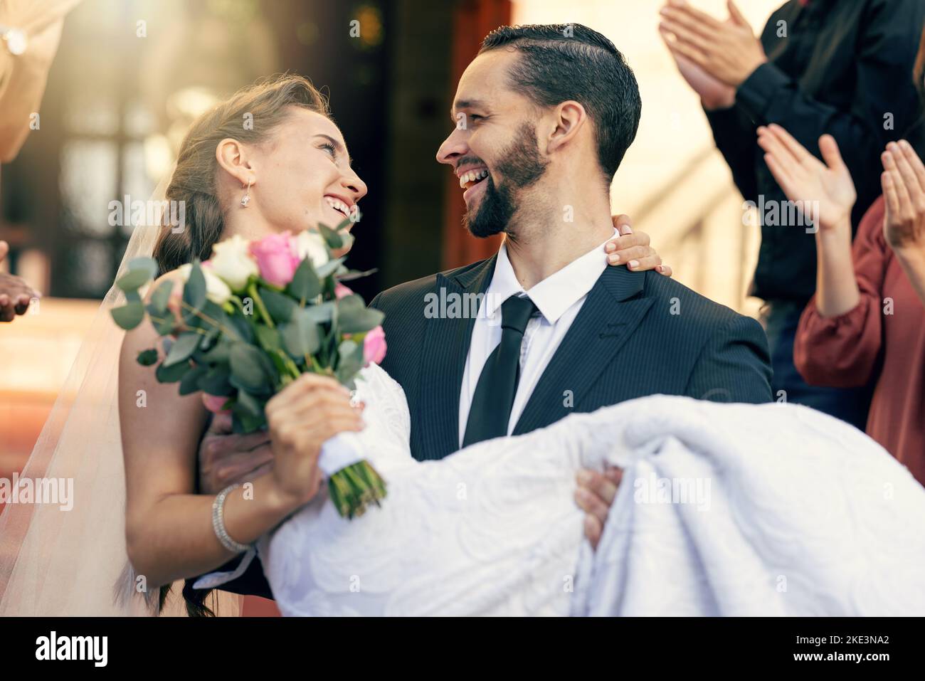 Newlyweds kissing while exiting the church after wedding ceremony, family  and friends celebrating their love with the shower of soap bubbles, custom  Stock Photo - Alamy