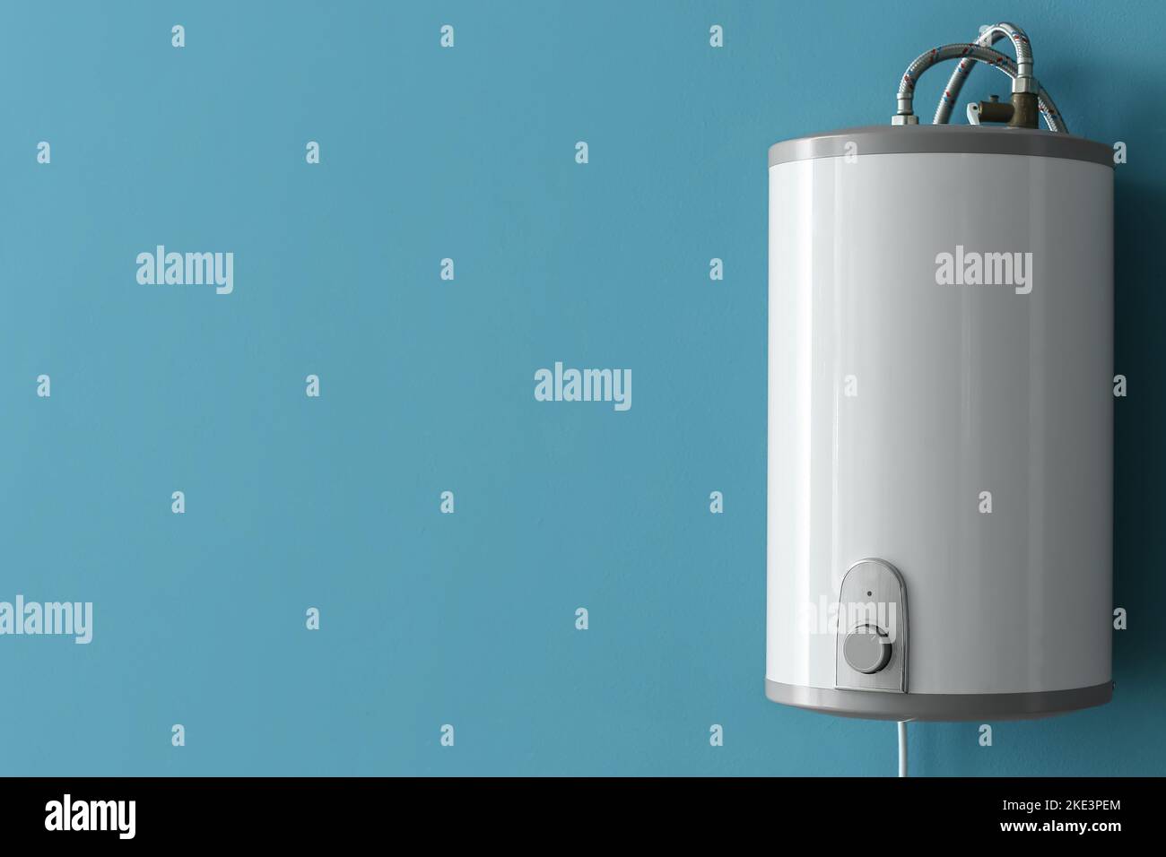 Modern electric boiler on blue wall Stock Photo - Alamy