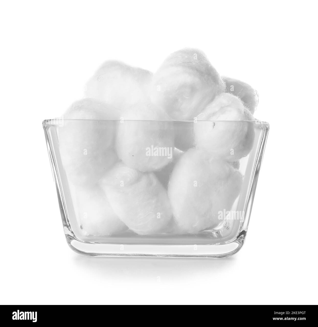 Bowl of soft cotton balls on white background Stock Photo