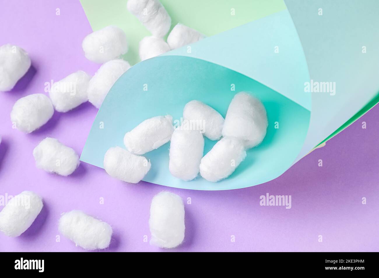 Paper sheets with cotton balls on lilac background Stock Photo Alamy
