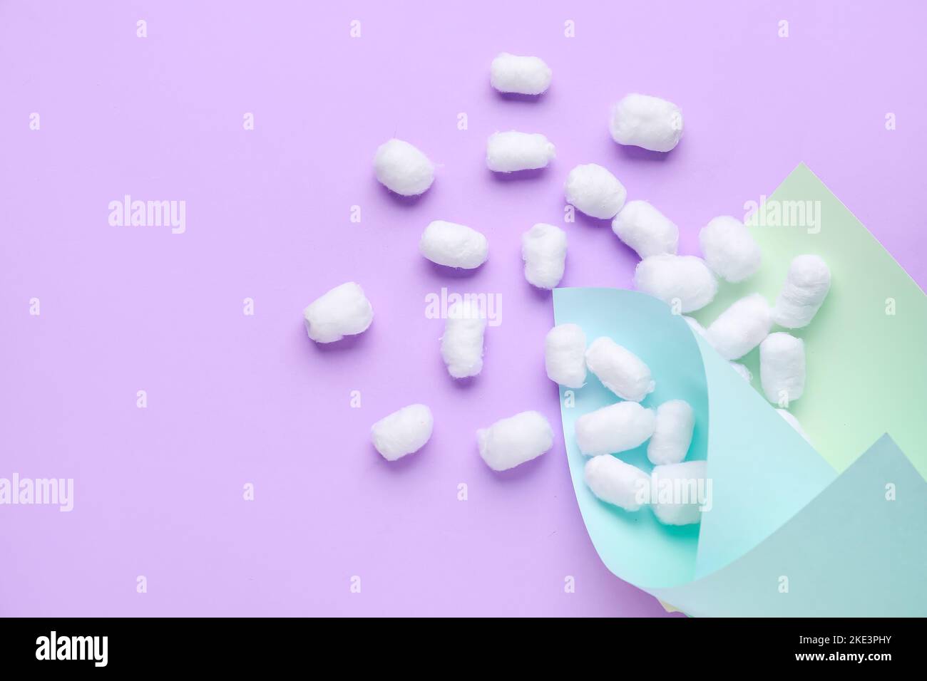 Paper sheets with cotton balls on lilac background Stock Photo Alamy
