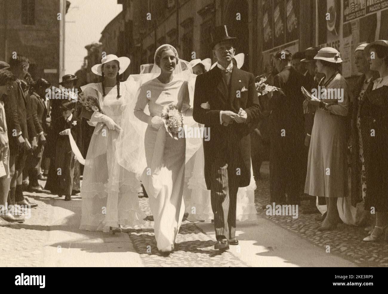 Just married couple out in the street with people around, Italy 1920s Stock Photo