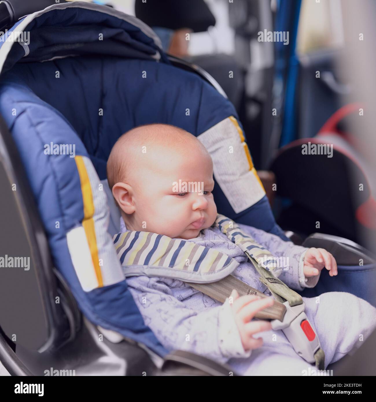 Safe and snug. Cropped shot a baby boy sitting alone in a car seat