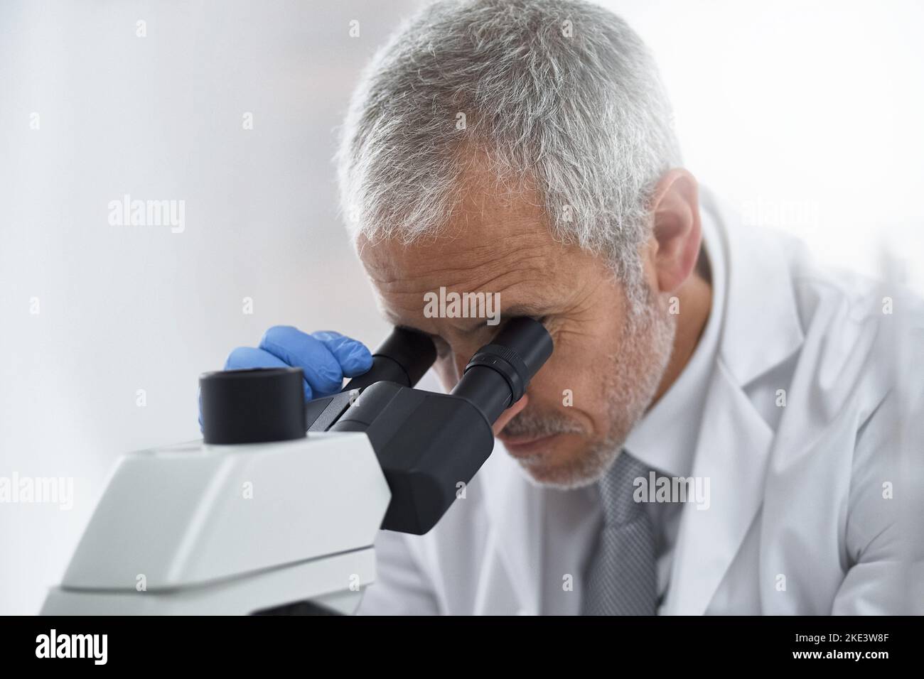 Advancing medicine through research. a researcher at work on a microscope in a lab. Stock Photo