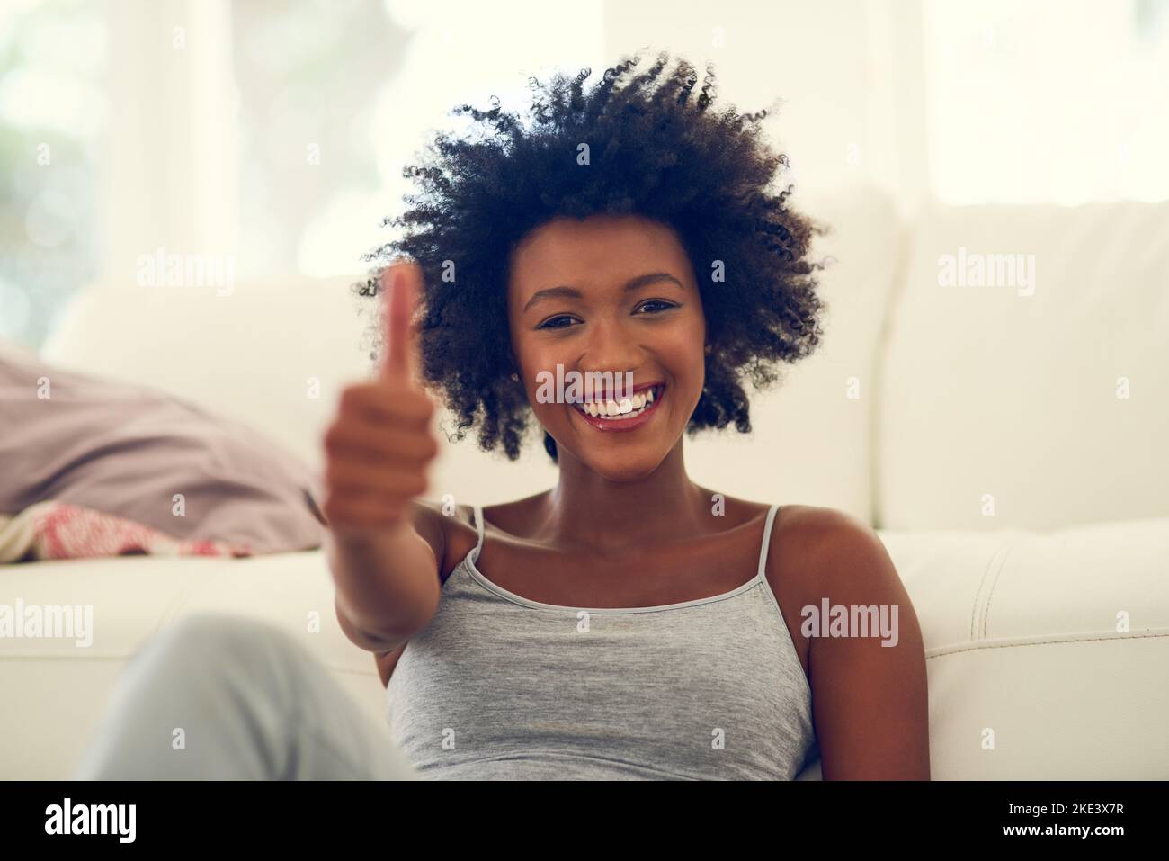 Thumbs up african woman sitting hi-res stock photography and images - Alamy