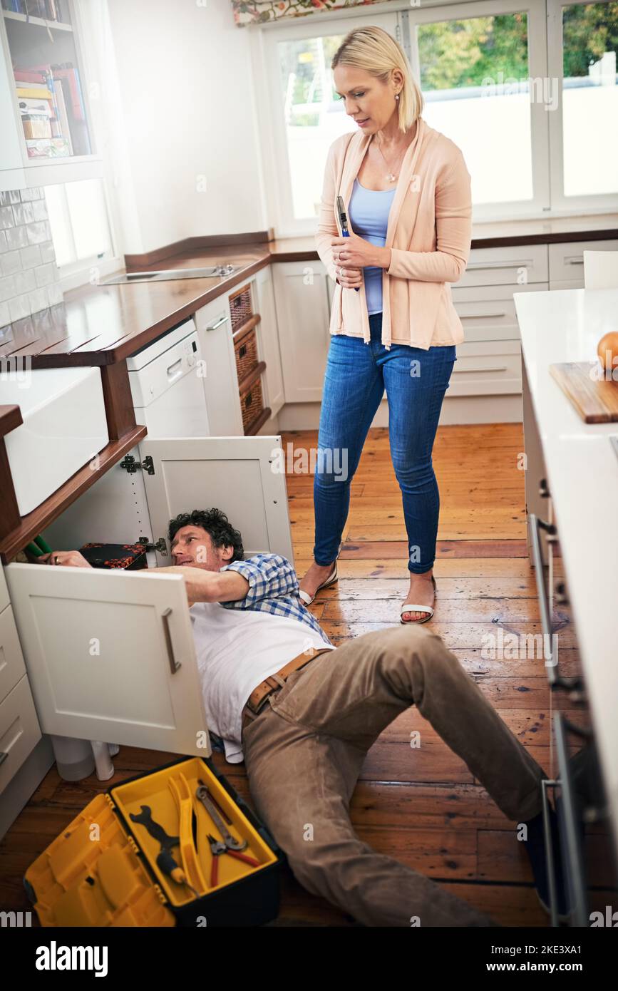 Woman fixing plumbing under sink hi-res stock photography and images - Alamy