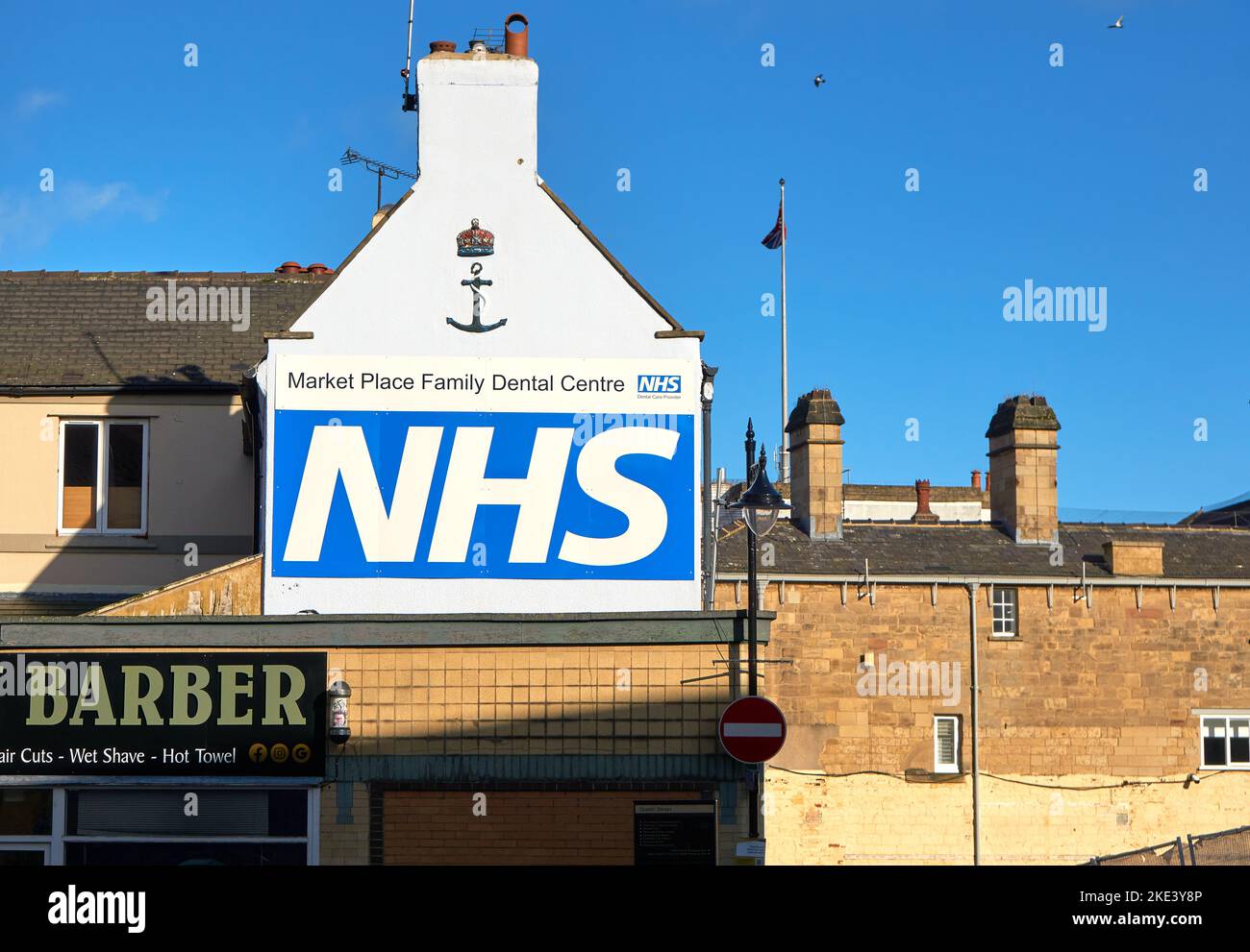 British NHS logo on a white wall in Mansfield, Nottinghamshire, UK