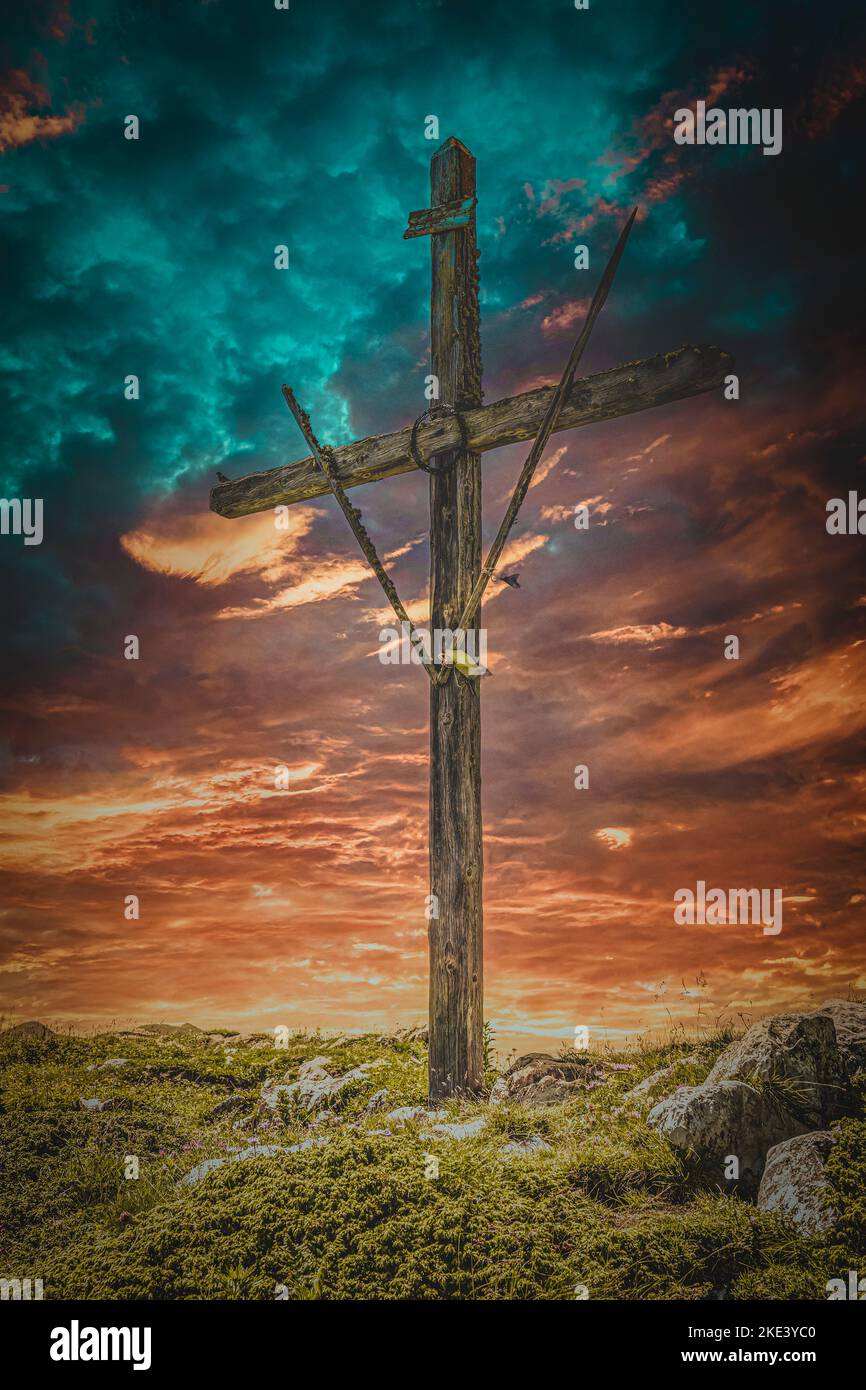 wooden cross and dramatic sunset sky Stock Photo
