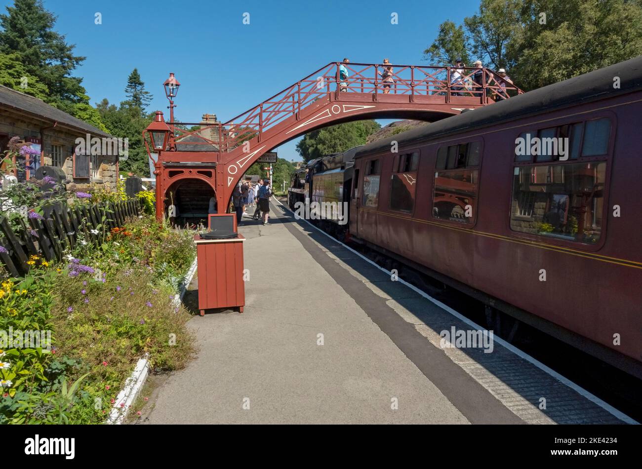 People tourists visitors on Goathland steam train station platform in summer North Yorkshire Moors Railway near Whitby North Yorkshire England UK Stock Photo