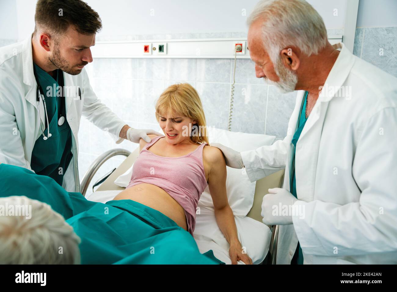 Woman giving birth in labor room of hospital Stock Photo