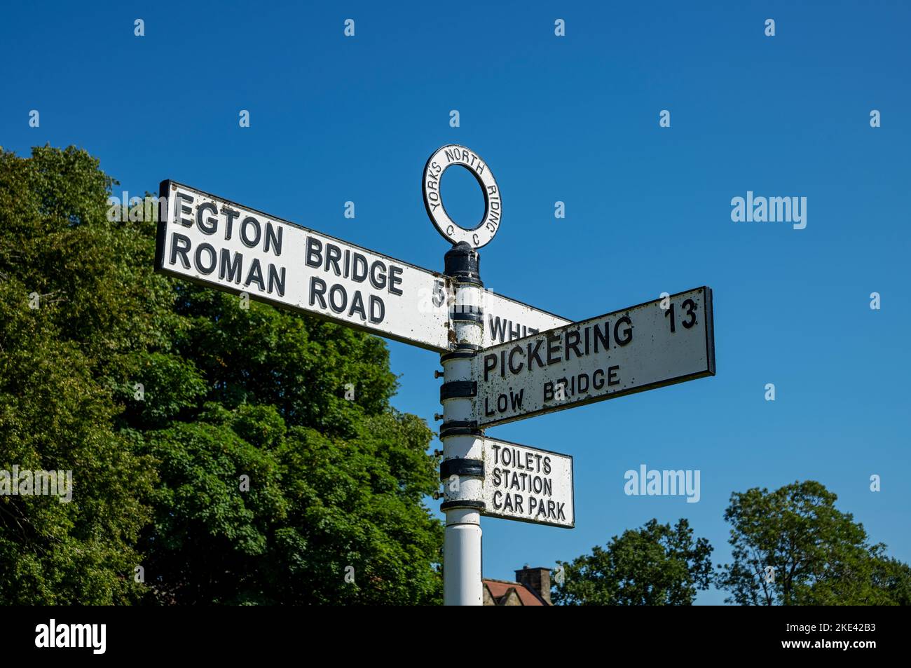 Close up of old metal road sign post showing directions to Egton Bridge and Pickering in summer Goathland near Whitby North Yorkshire England UK Stock Photo