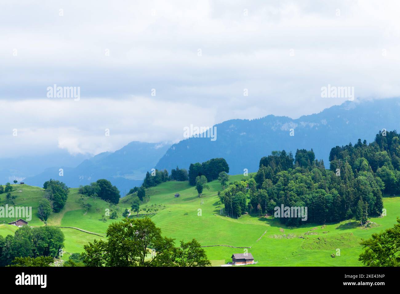 Panoramic view of green alpine meadows and the Alps mountains in ...