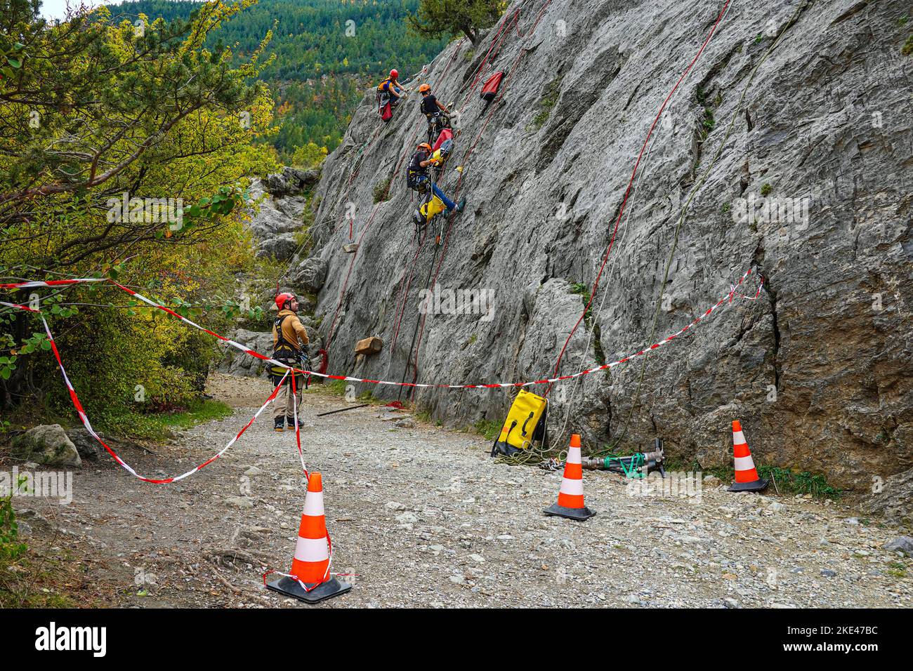 Cavers practising with ropes on a cliff face at Autumn in the Alps Maritimes, French Alps, Alps, France, EU Stock Photo