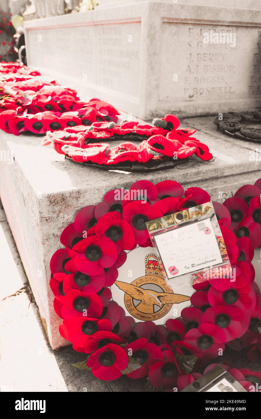 Remembrance Day poppy wreaths laid on the steps of the war memorial in Witney, Oxfordshire for Remembrance Sunday to commerate the dead in all wars. Stock Photo