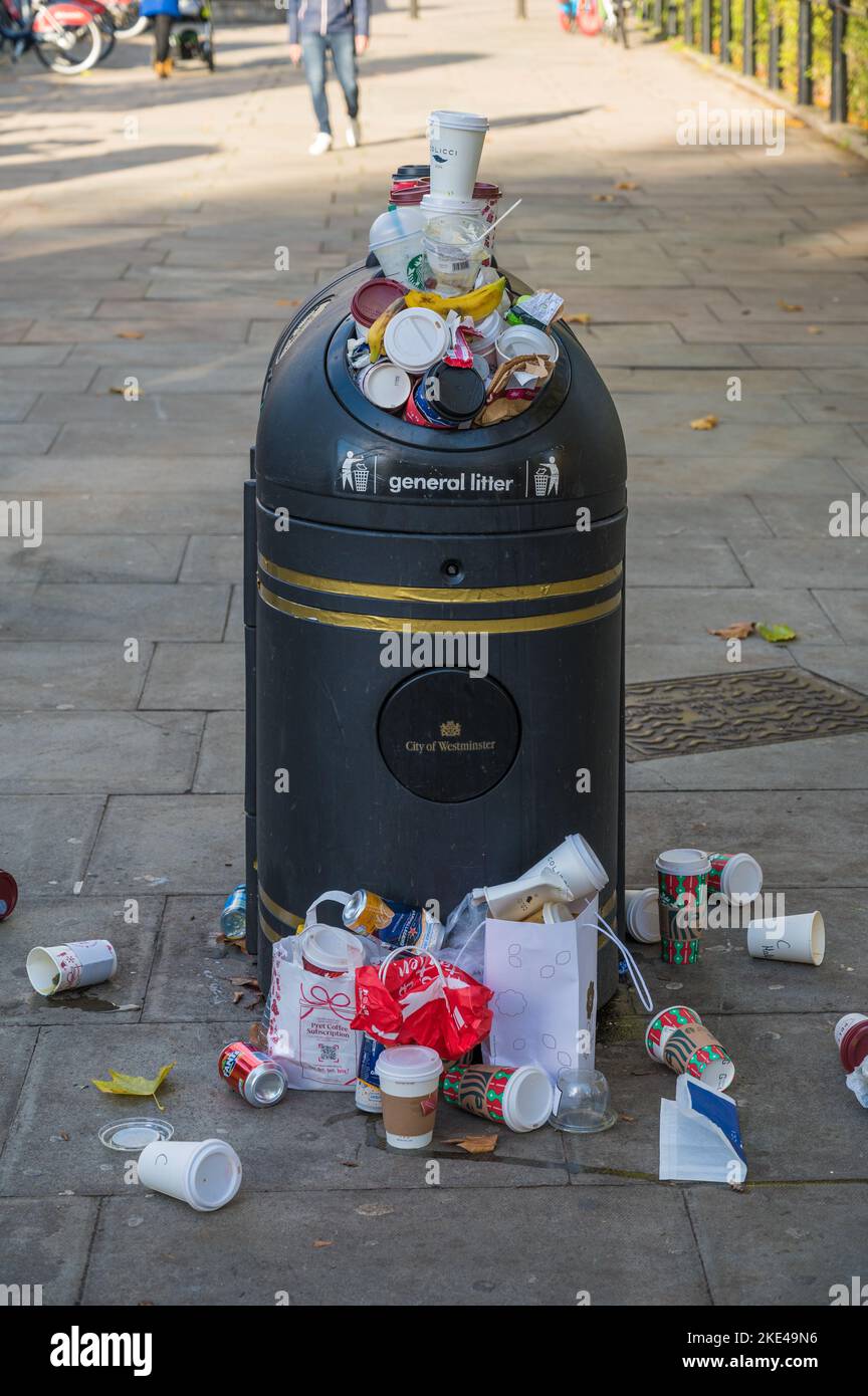 Overspilling municipal litter bin in Green Park, London, England, UK